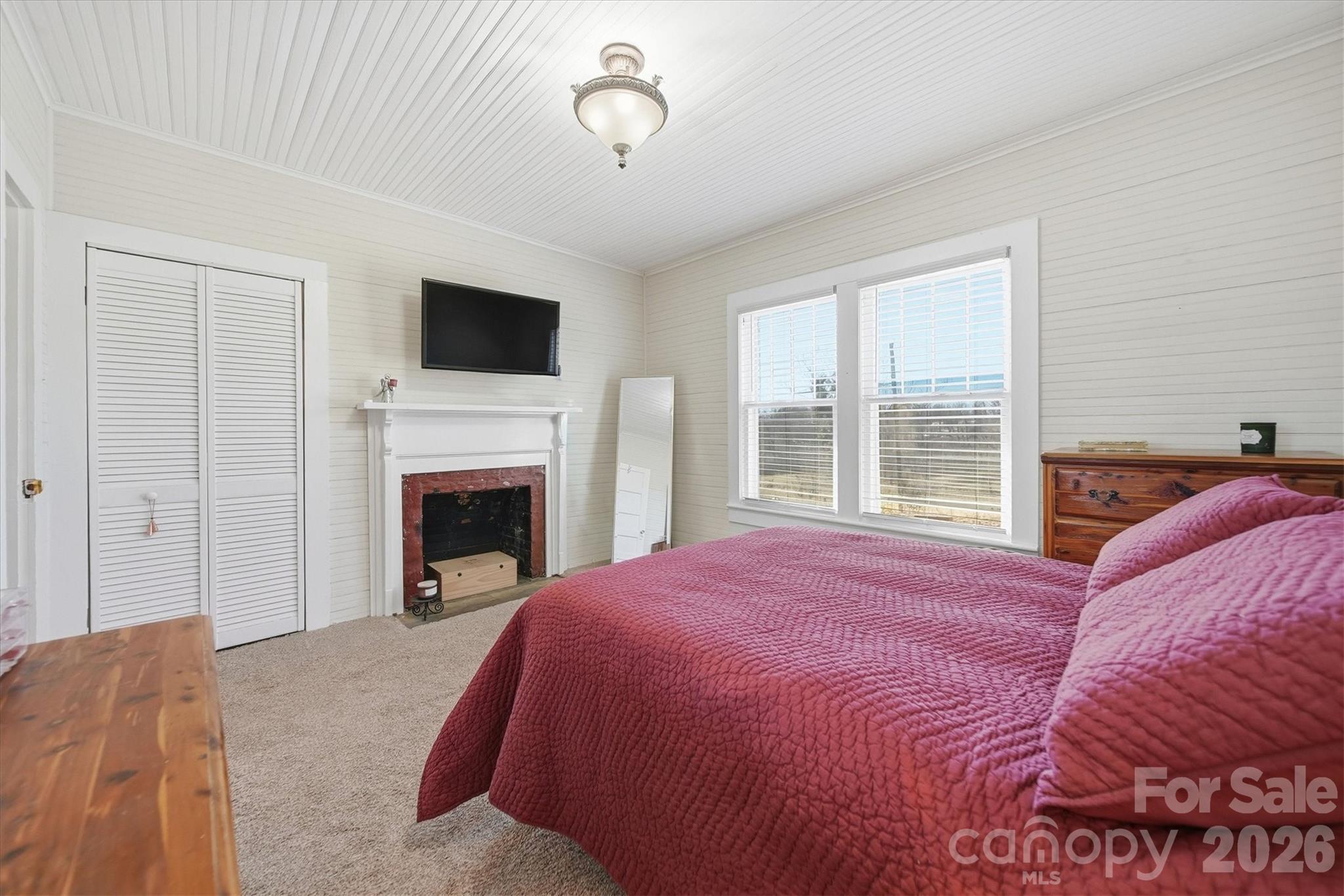 113 Leonhardt Road Morganton, NC 28655 - Photo 19 of 44 a bed room with a bed and a fireplace