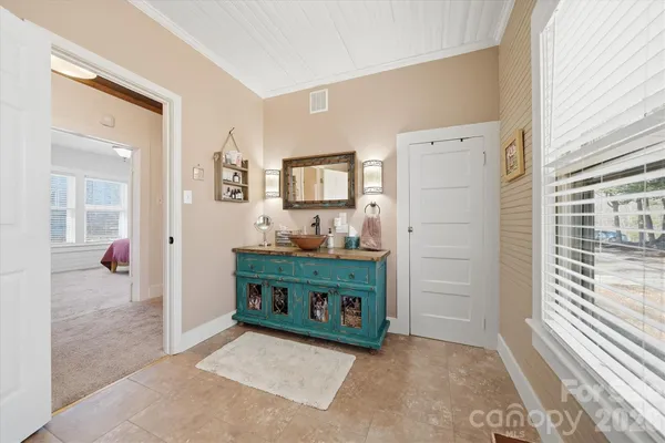 hallway with mirror and window