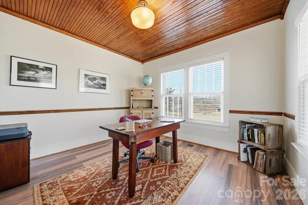 a workspace with furniture and wooden floor