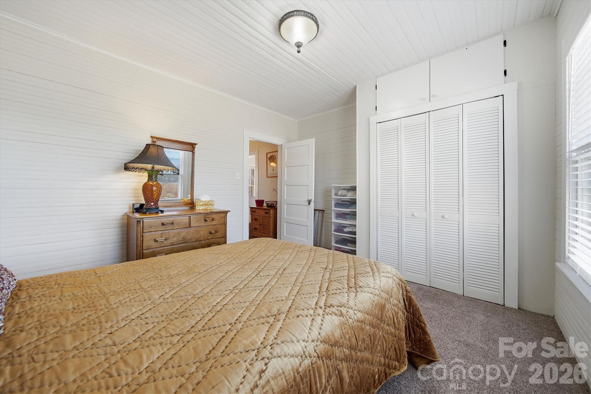 113 Leonhardt Road Morganton, NC 28655 - Photo 29 of 44 a bedroom with a large bed and a chandelier