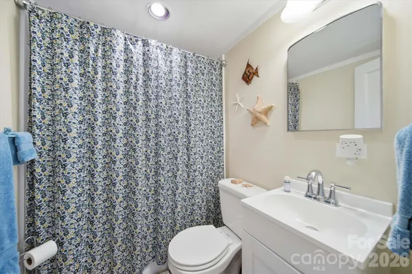 a white toilet sitting next to a bathroom sink