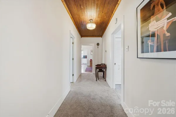 a view of a hallway with a dining area