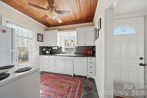 a kitchen with stainless steel appliances a stove a sink and a refrigerator
