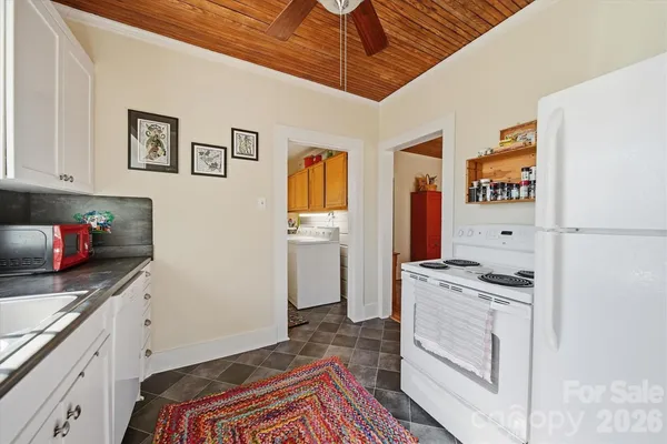 a kitchen with stainless steel appliances granite countertop a stove a refrigerator and a microwave