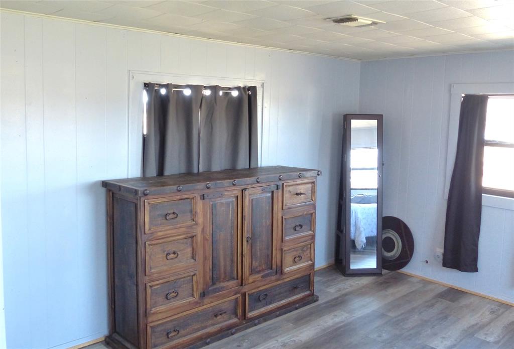 286 North Fm 1851 Voca, TX 76887 - Photo 11 of 23 Bedroom featuring wood finished floors, visible vents, and crown molding