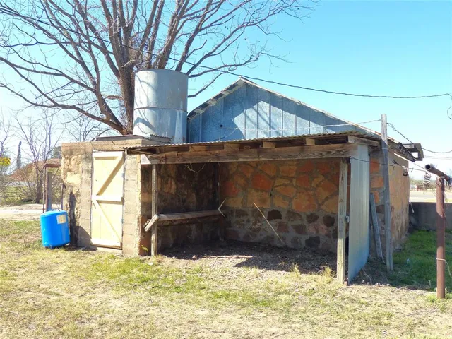 a view of a house with backyard porch and sitting area