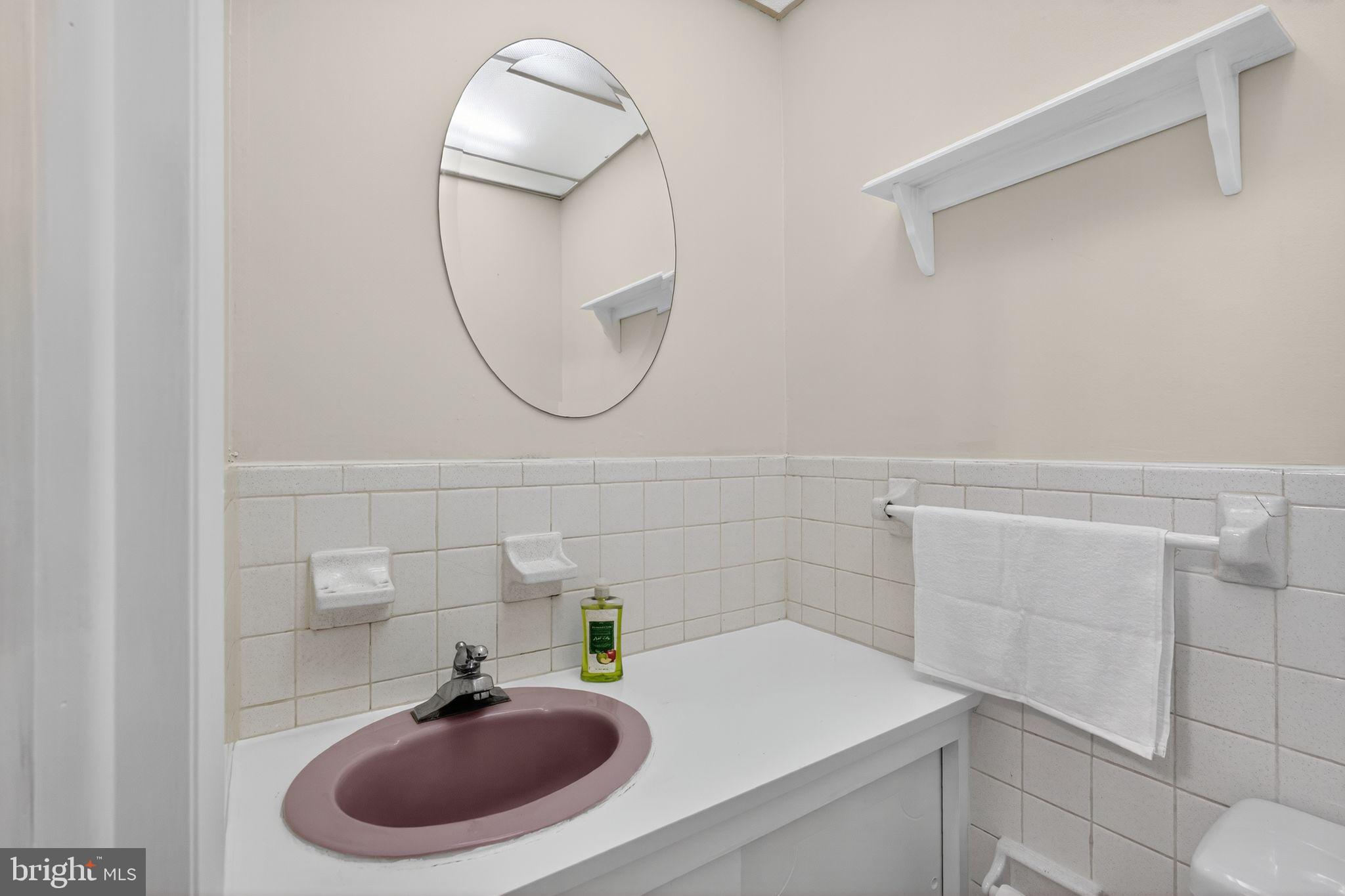 2919 Robbins Street Philadelphia, PA 19149 - Photo 12 of 32 a bathroom with a sink and a mirror