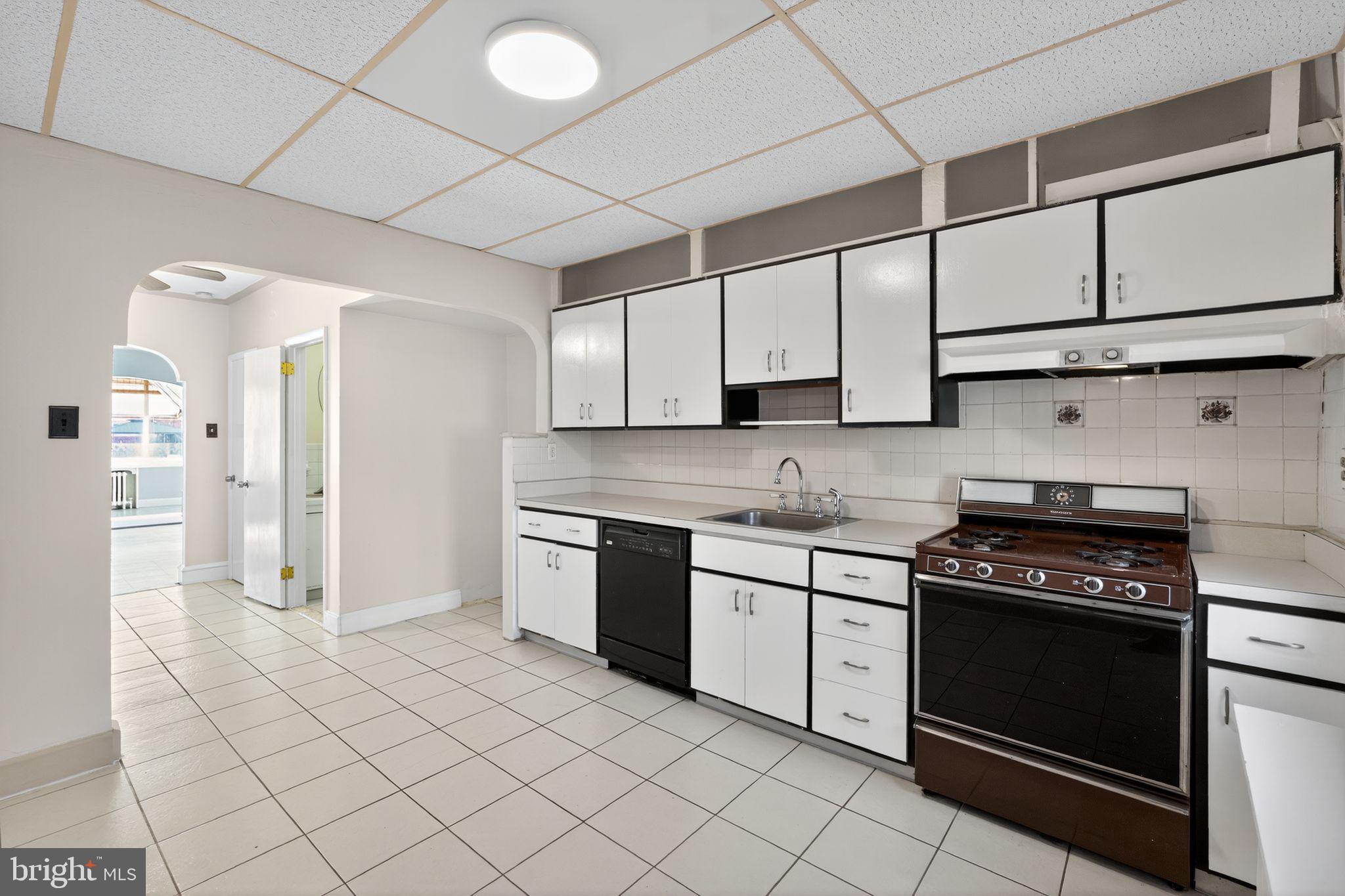 2919 Robbins Street Philadelphia, PA 19149 - Photo 14 of 32 a kitchen with white cabinets and appliances