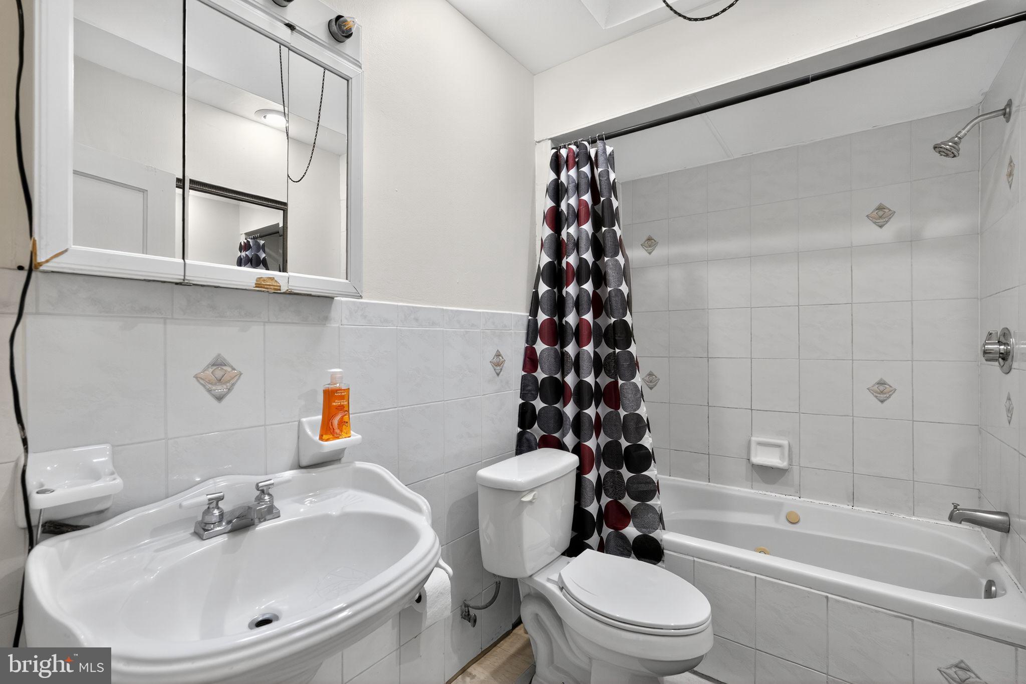 2919 Robbins Street Philadelphia, PA 19149 - Photo 26 of 32 a bathroom with a sink toilet and shower