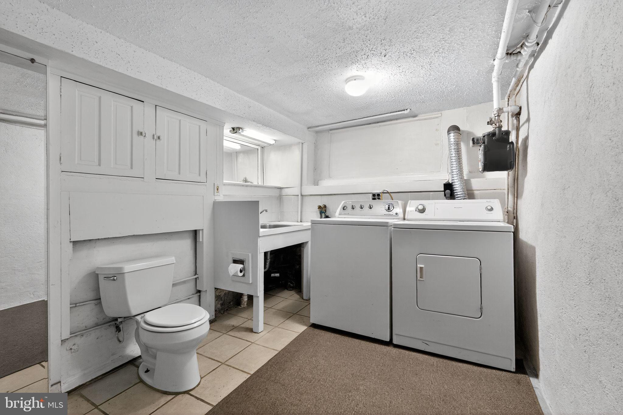 2919 Robbins Street Philadelphia, PA 19149 - Photo 29 of 32 a bathroom with a toilet sink and mirror