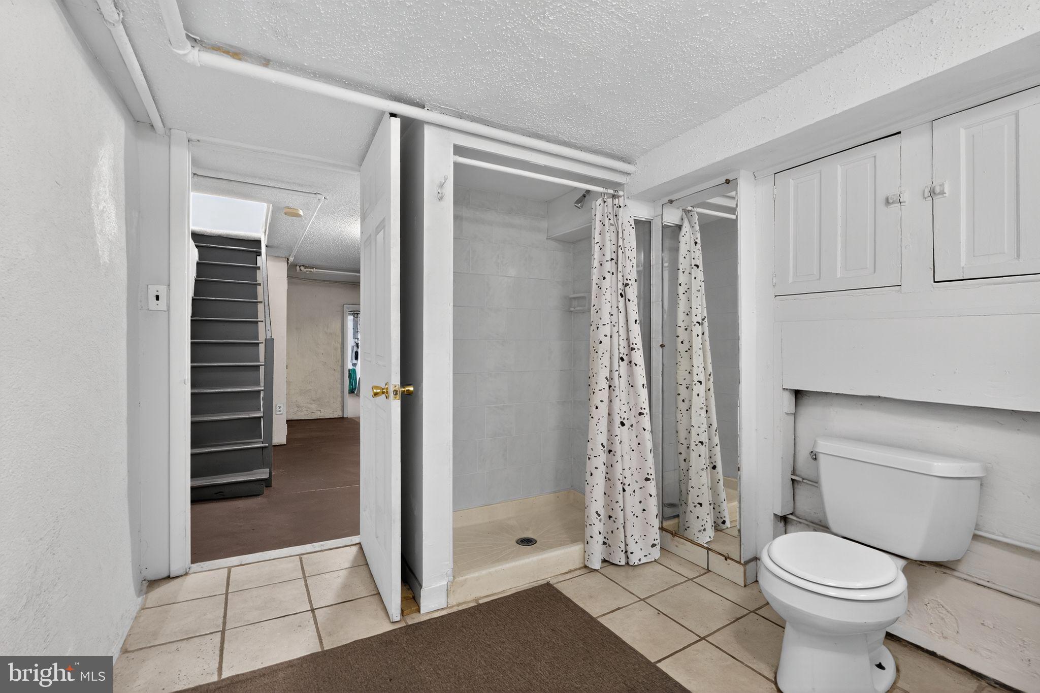 2919 Robbins Street Philadelphia, PA 19149 - Photo 30 of 32 a bathroom with a shower and a toilet