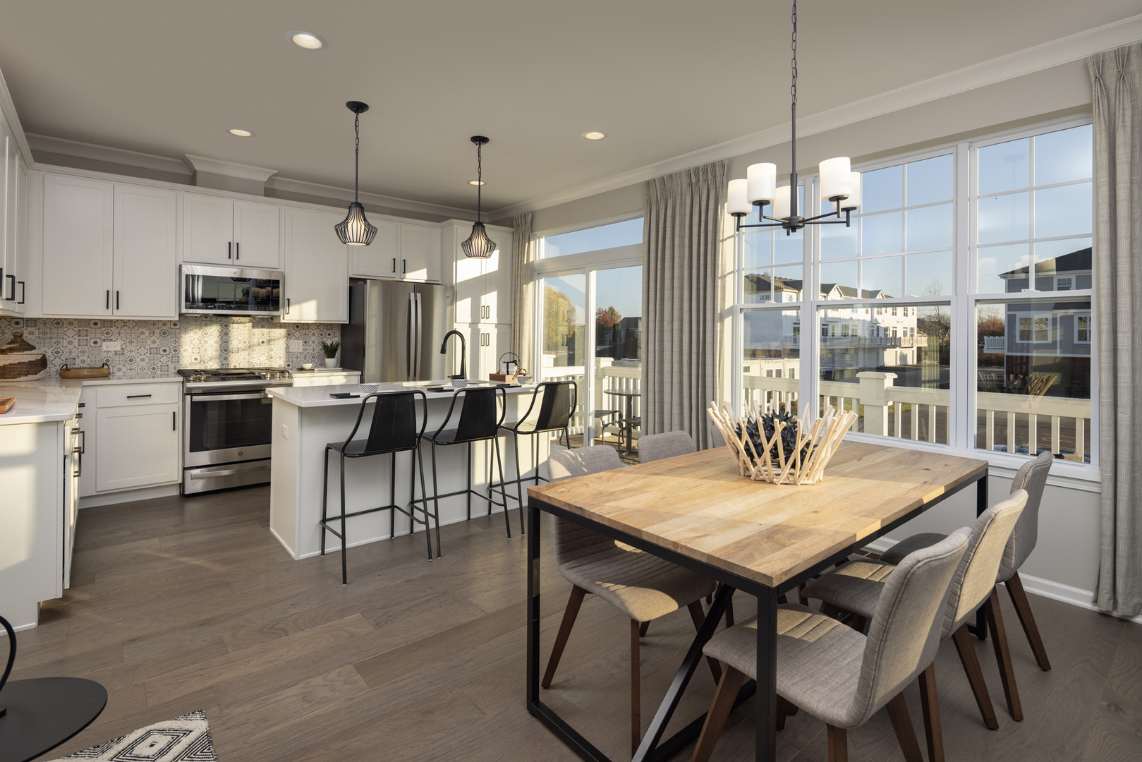 301 Timberleaf Circle Roselle, IL 60172 - Photo 5 of 17 a kitchen with stainless steel appliances kitchen island granite countertop a dining table chairs and white cabinets