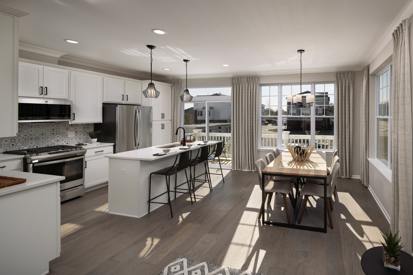 301 Timberleaf Circle Roselle, IL 60172 - Photo 7 of 17 a kitchen with kitchen island a dining table chairs stainless steel appliances and cabinets