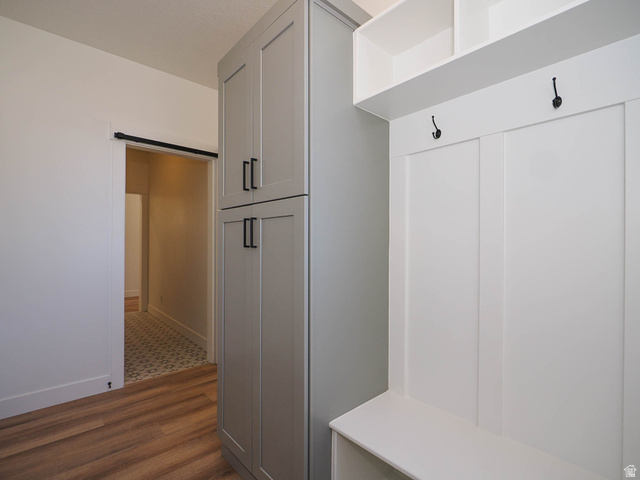 3938 North Wood Road Eagle Mountain, UT 84005 - Photo 28 of 55 Mudroom with dark wood finished floors and a barn door