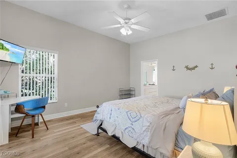 a bedroom with a bed and a chair