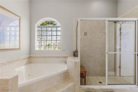 a bathroom with a window a shower and a window