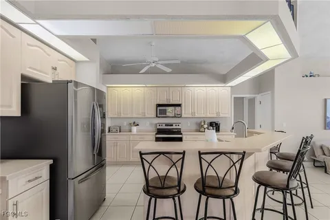 a kitchen with stainless steel appliances a refrigerator and a stove top oven