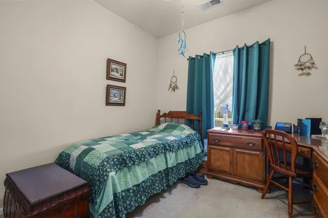 a bedroom with a bed and a table in it