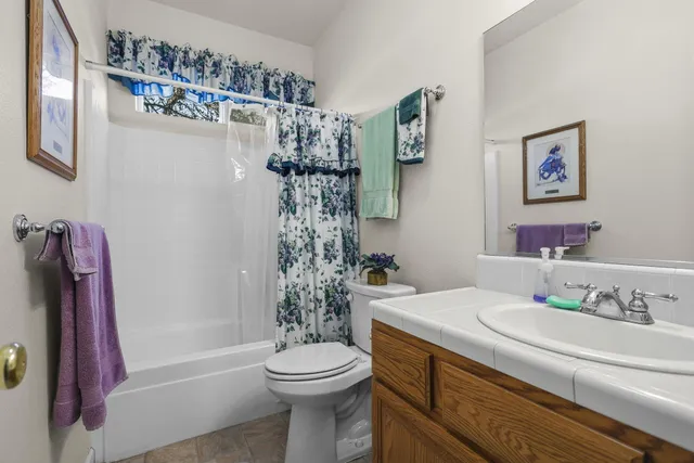 a bathroom with a toilet sink and shower