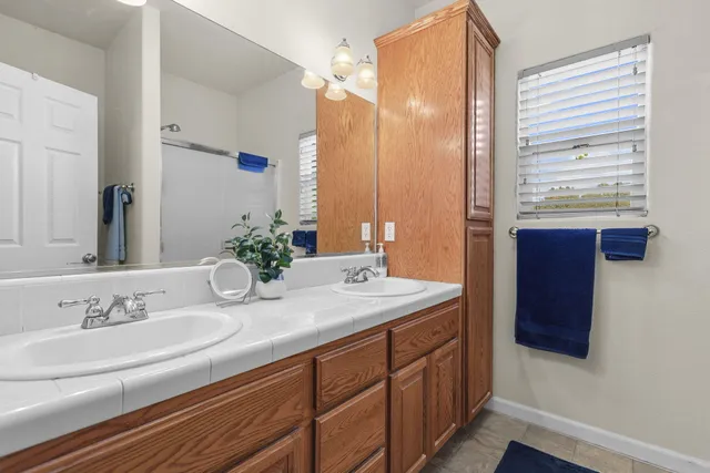 a bathroom with a double vanity sink and a mirror