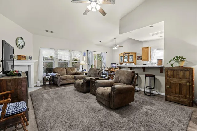 a living room with furniture and a chandelier