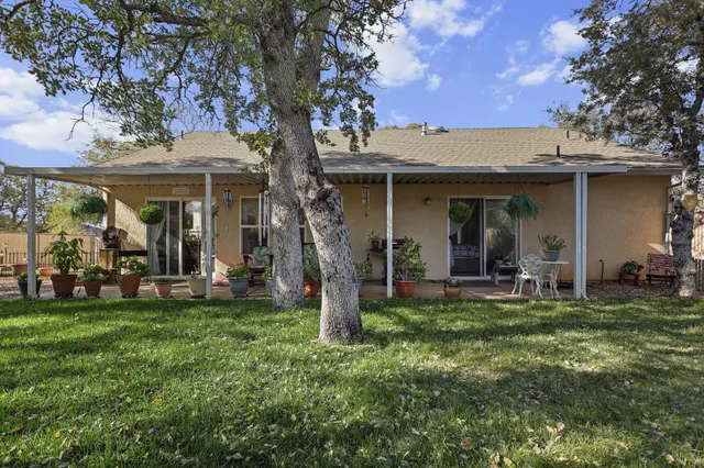 a view of a house with backyard porch and sitting area