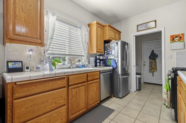 a kitchen with stainless steel appliances a refrigerator sink and cabinets
