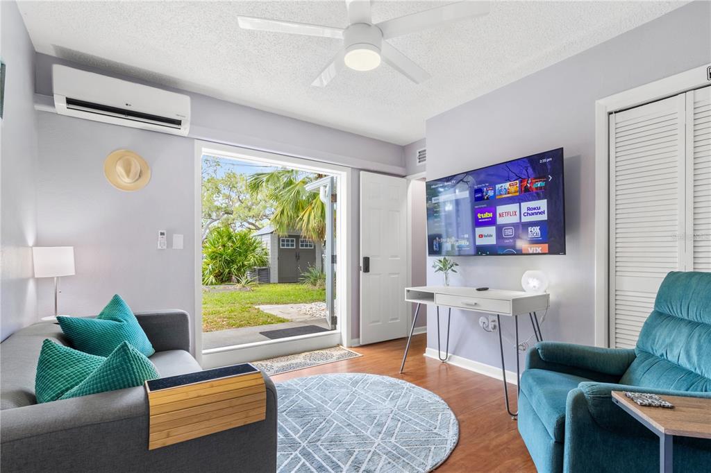 5596 100th Way North St. Petersburg, FL 33708 - Photo 27 of 67 a living room with furniture and a flat screen tv