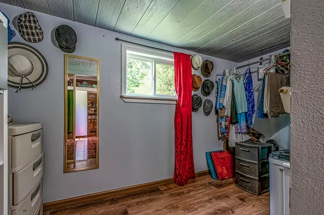 a front view of a house with a yard and trees