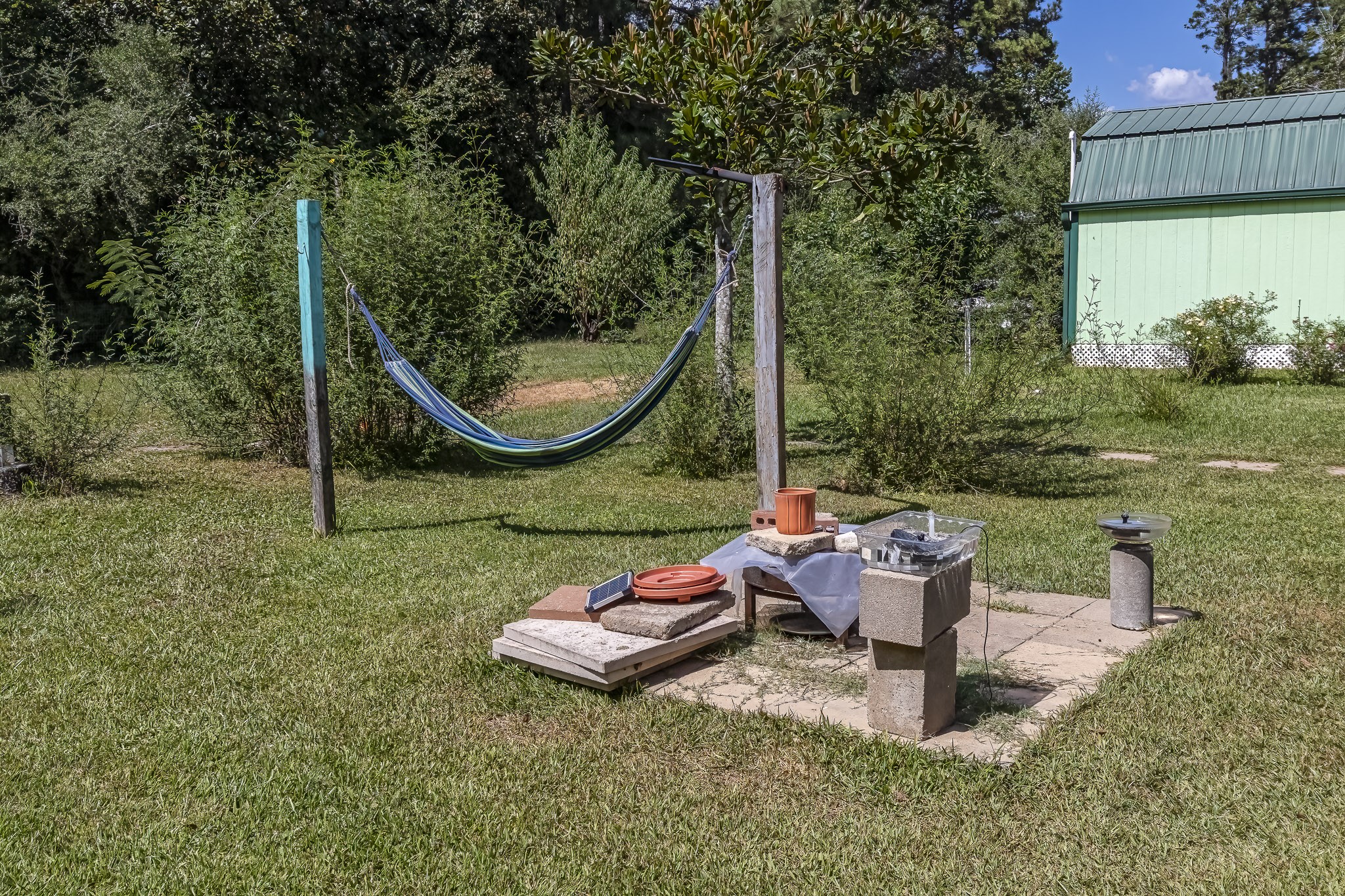 121 Tidwell Road Shepherd, TX 77371 - Photo 18 of 21 a backyard of a house with outdoor seating