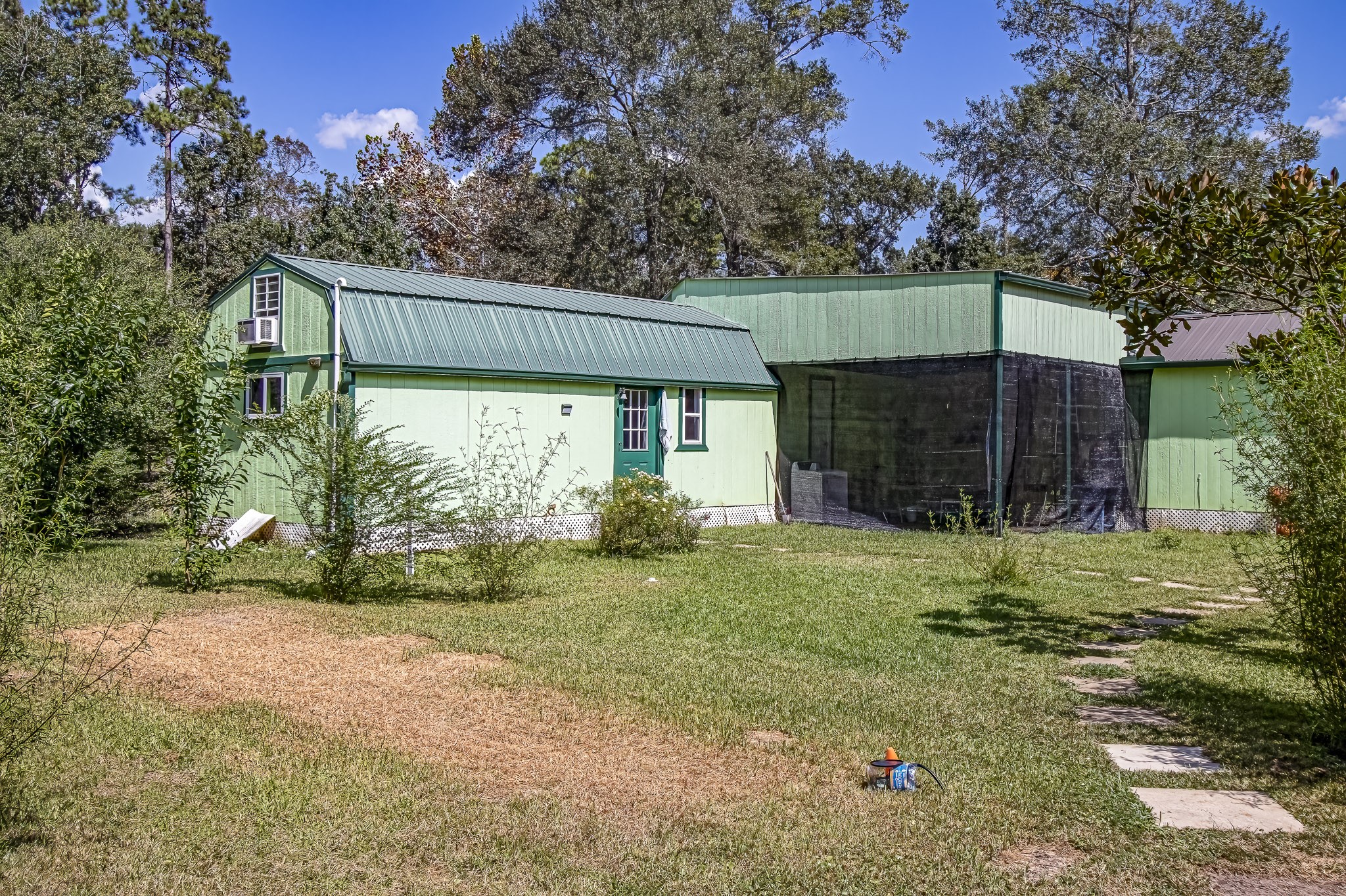 121 Tidwell Road Shepherd, TX 77371 - Photo 19 of 21 a backyard of a house with plants and large trees