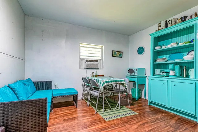 a view of kitchen with furniture and wooden floor