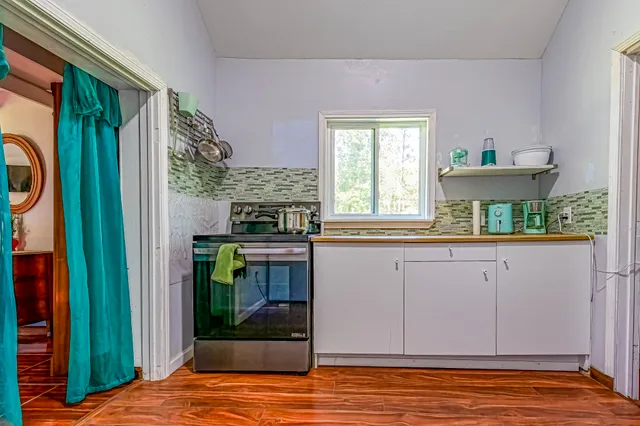 a view of kitchen with granite countertop cabinets
