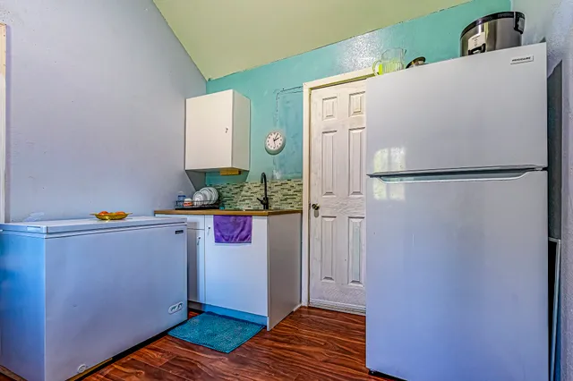 a white refrigerator freezer sitting inside of a kitchen