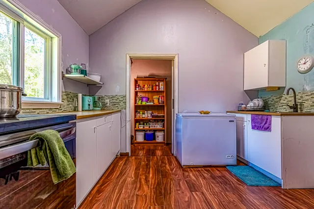 a room with wooden floor and furniture