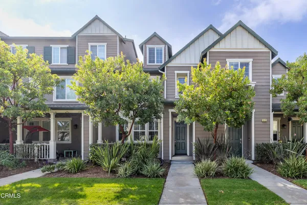 a front view of a house with yard and green space