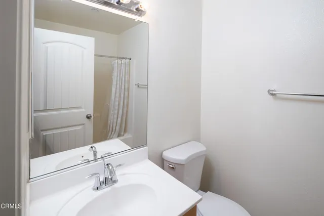a bathroom with a sink toilet and mirror