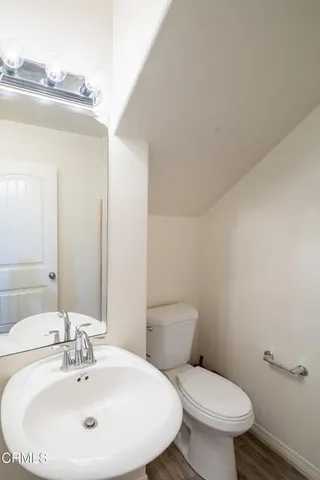 a white toilet sitting next to a bathroom sink