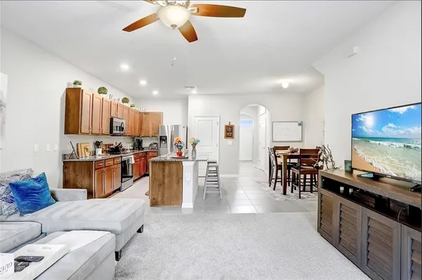 a living room with furniture and kitchen view