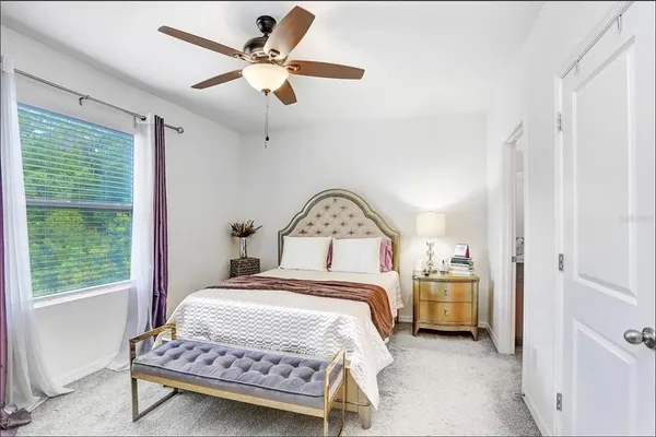 a bedroom with a bed and a table in it