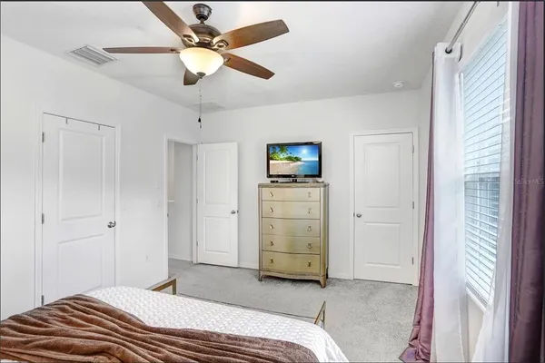 a bedroom with a bed and a chandelier