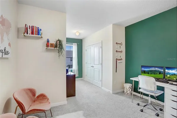 a view of a livingroom with furniture and a chair