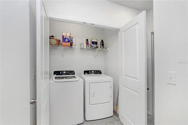 a view of storage and utility room with washer and dryer