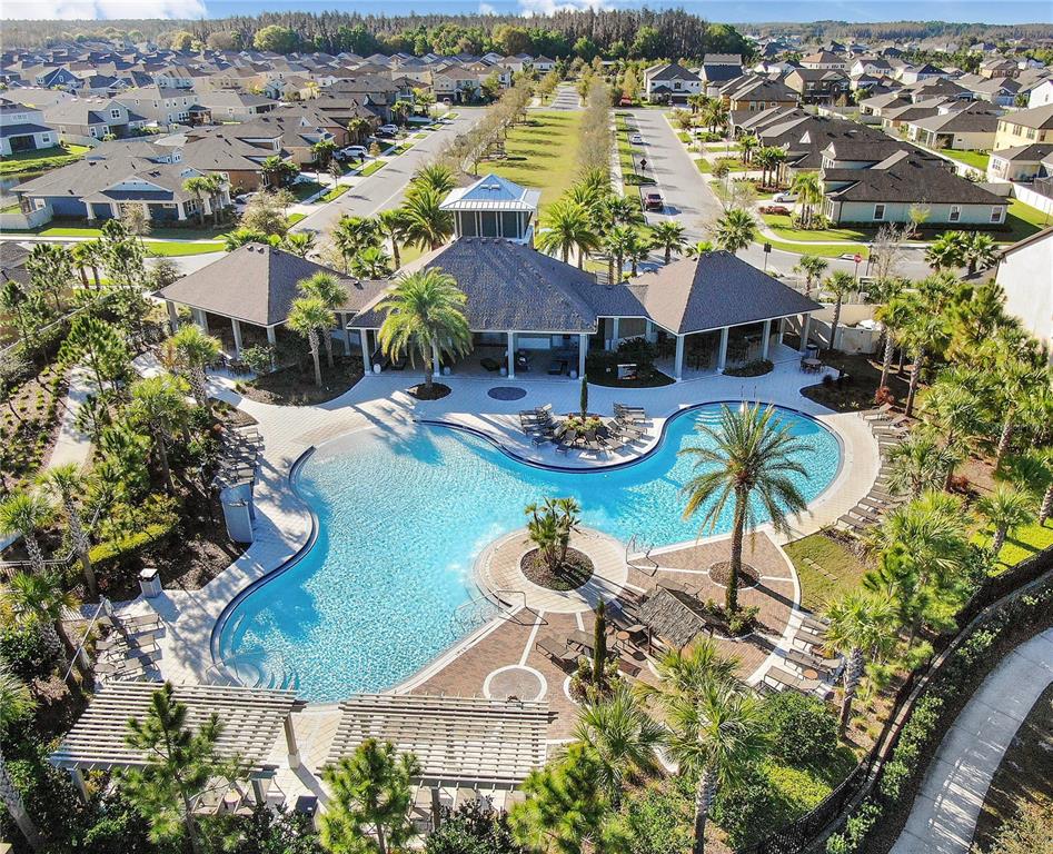 32934 Kaloko Road Wesley Chapel, FL 33543 - Photo 32 of 39 an aerial view of house with yard swimming pool and ocean view