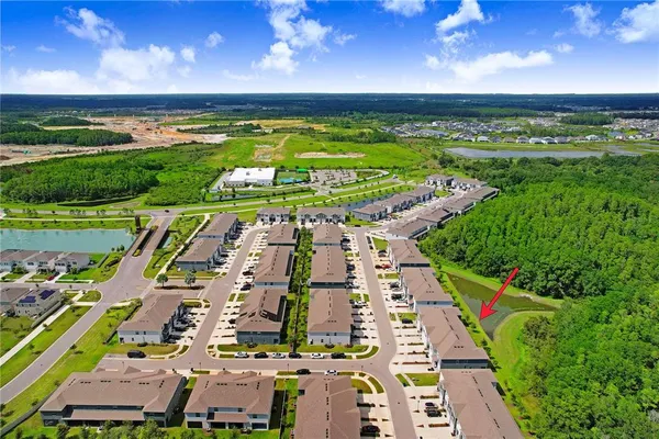 an aerial view of a building with an outdoor space and seating area