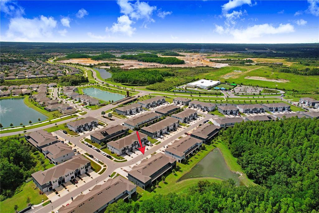 32934 Kaloko Road Wesley Chapel, FL 33543 - Photo 38 of 39 an aerial view of a building with an outdoor space and seating area