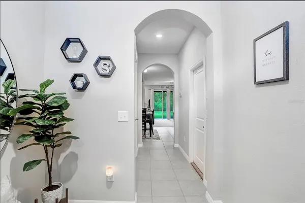 a hallway with painting and a potted plant