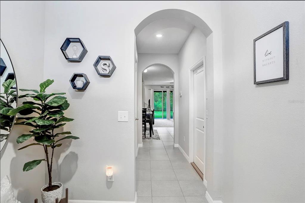 32934 Kaloko Road Wesley Chapel, FL 33543 - Photo 4 of 39 a hallway with painting and a potted plant