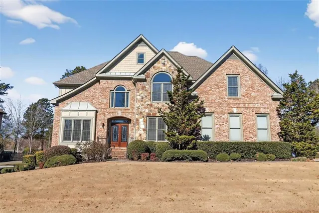 a front view of a house with yard and garage