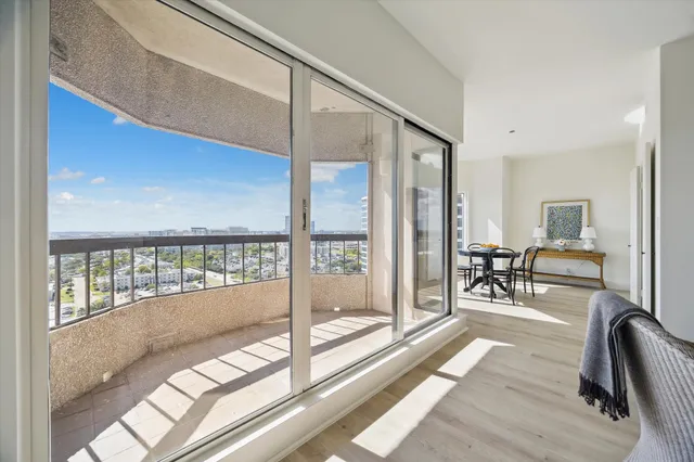 a view of a balcony furniture and floor to ceiling window